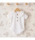 body bebé blanco cuello polo botones algodón suave detalle verano clásico elegante