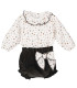Conjunto bebé navideño con blusa estampada y pololo de pana oscuro. Fondo blanco