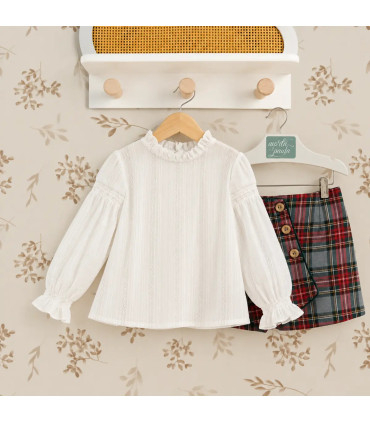 Conjunto infantil Marta y Paula de camisa blanca y falda de cuadros.Fondo estudio.