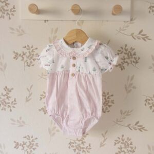 pelele bebé rosa algodón estampado barcos volante fruncido cuello rayas botones madera textura ligera